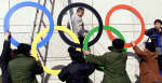 Workers prepare to raise the Olympic rings onto a sign featuring Beijing as a candidate city for the 2008 Games. REUTERS/Chien-Min Chung 