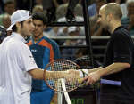 Sebastien Grosjean (L) shakes hands with Andre Agassi after their match. 