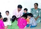Muthupandiyan with children at the CHES ashram